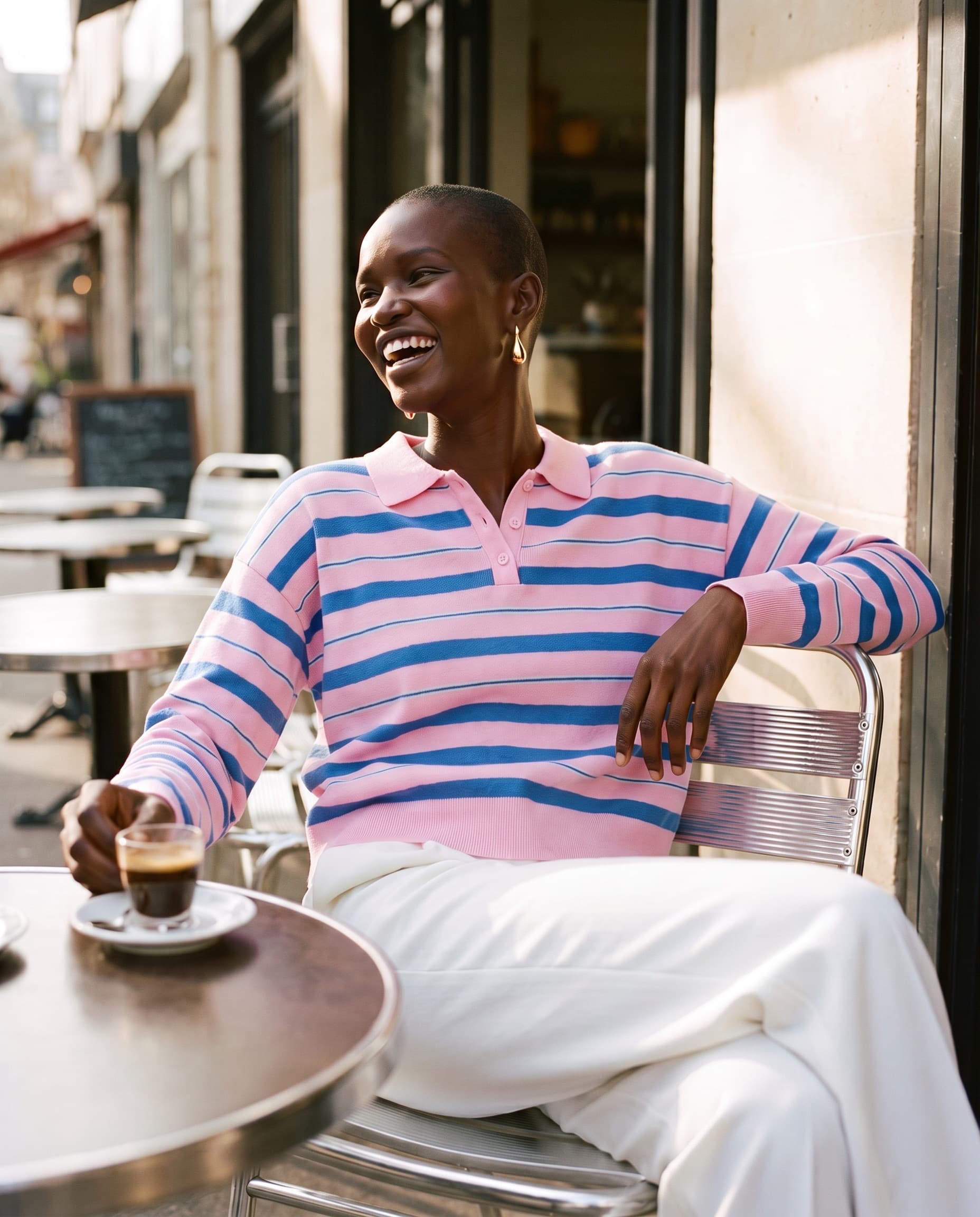 Striped polo knit on location at a café terrace